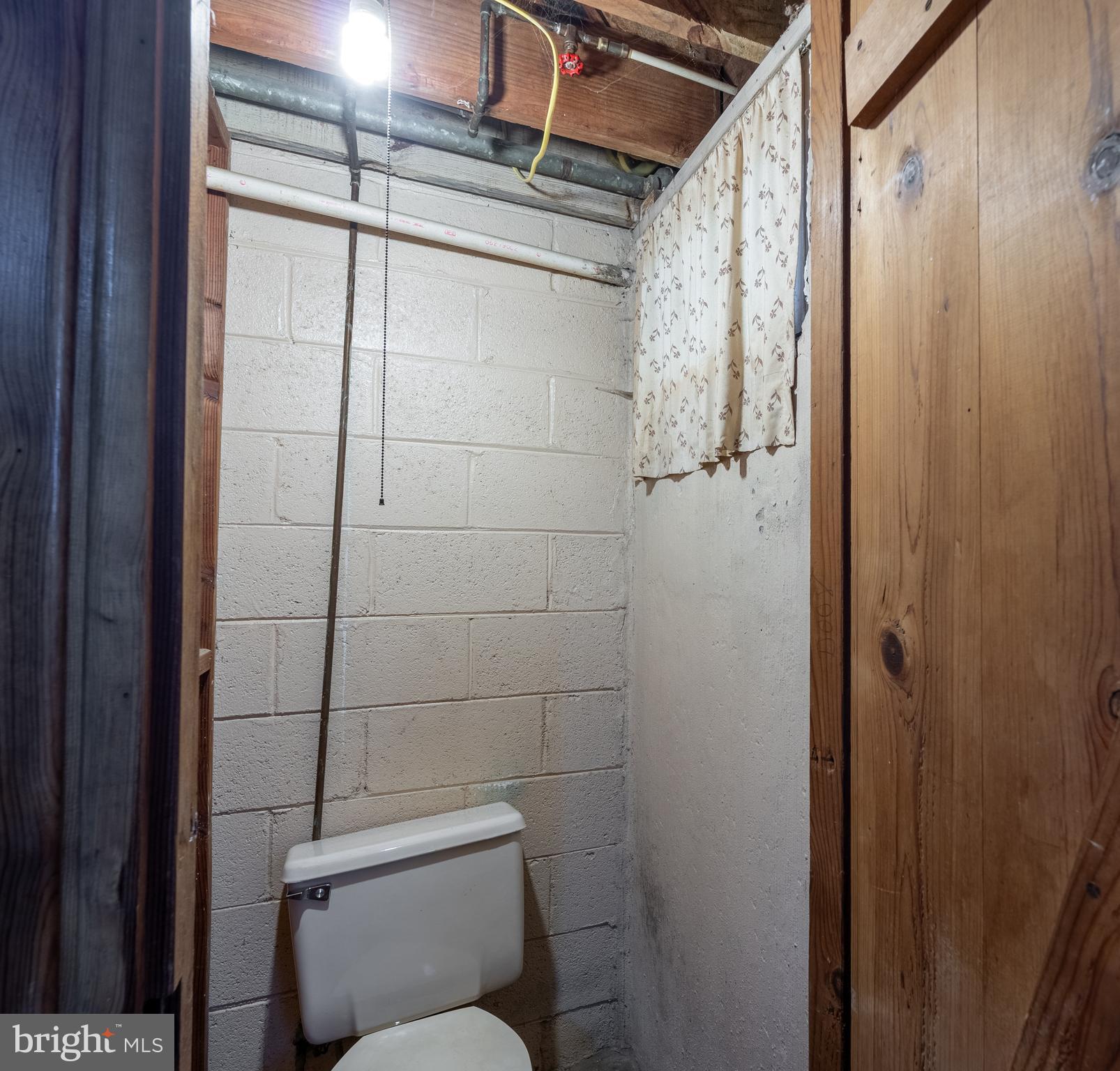 1738 Stokesley Road Baltimore, MD 21222 - Photo 24 of 34 a bathroom with a toilet and shower