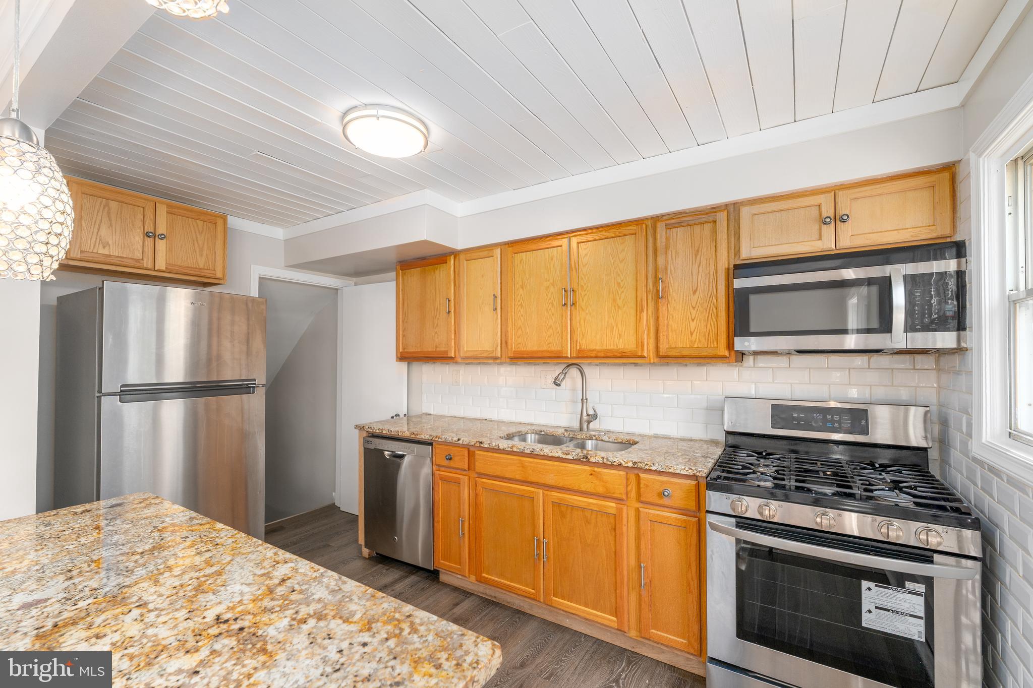 1738 Stokesley Road Baltimore, MD 21222 - Photo 3 of 34 a kitchen with stainless steel appliances granite countertop a stove a refrigerator and a microwave