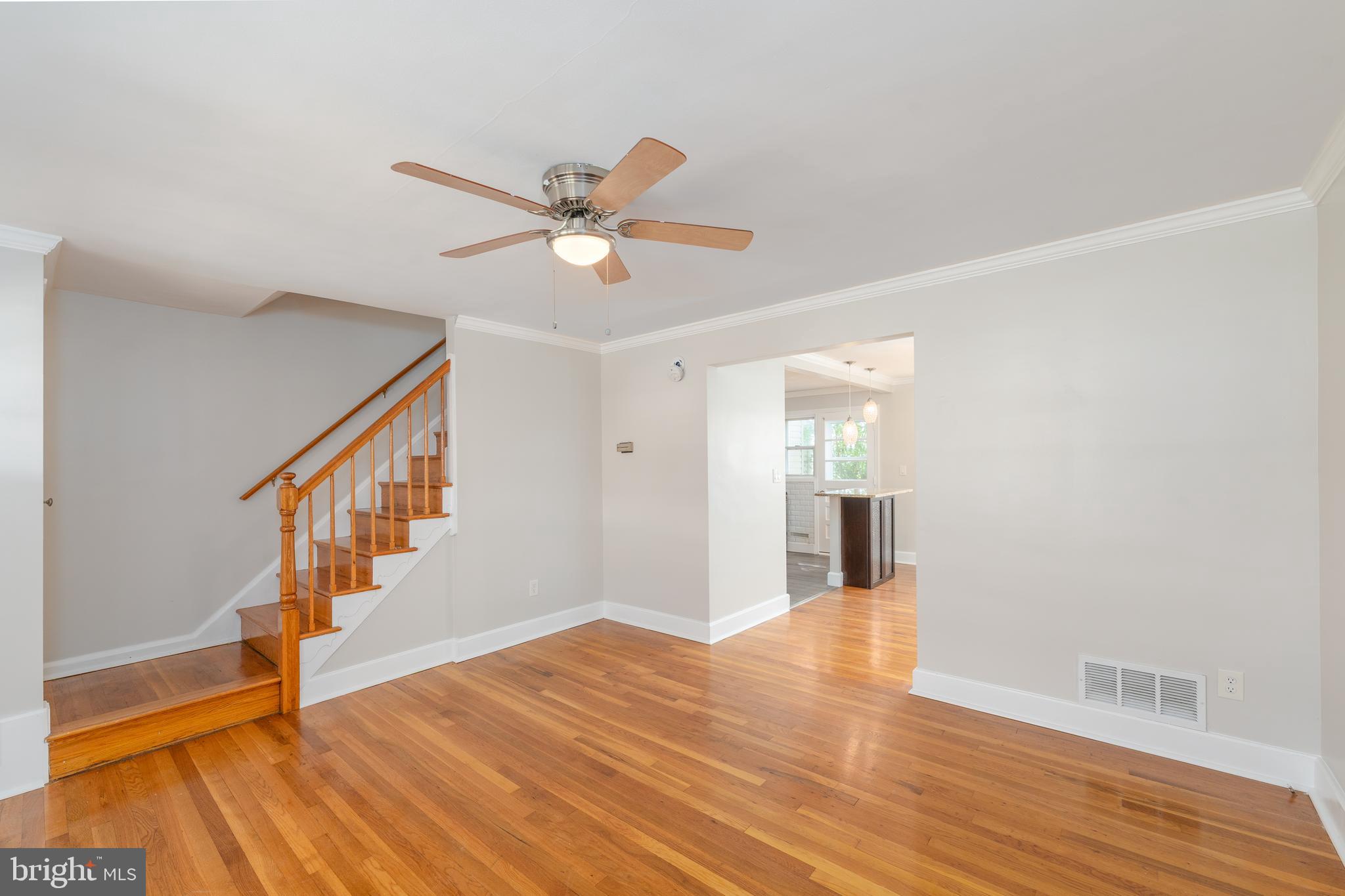 1738 Stokesley Road Baltimore, MD 21222 - Photo 4 of 34 a view of an empty room with wooden floor and a ceiling fan