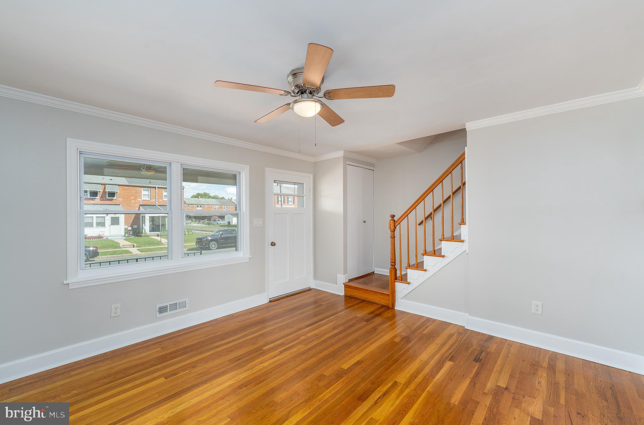 1738 Stokesley Road Baltimore, MD 21222 - Photo 5 of 34 a view of an empty room with wooden floor and a window