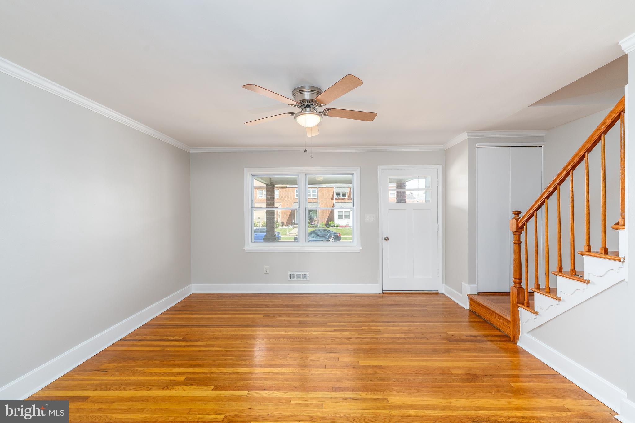 1738 Stokesley Road Baltimore, MD 21222 - Photo 6 of 34 a view of a room with wooden floor and a ceiling fan
