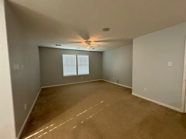 an empty room with a empty space and windows