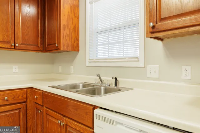 a kitchen with a sink and cabinets