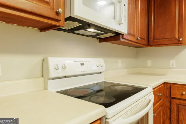 a kitchen with a cabinets and a refrigerator
