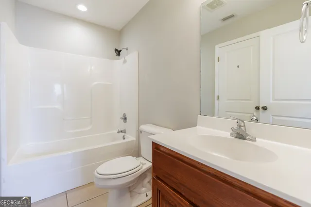 a bath room with a toilet a sink and a bathtub