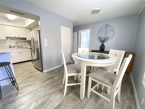 a dining room with furniture and wooden floor