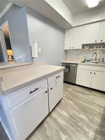 a kitchen with cabinets appliances and a sink