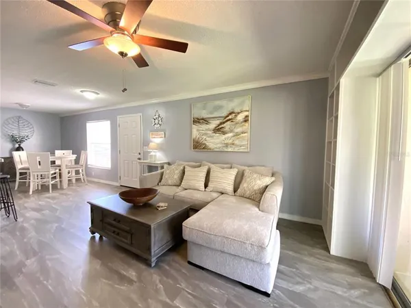a living room with furniture and a chandelier