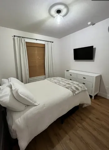a bedroom with a bed and a television