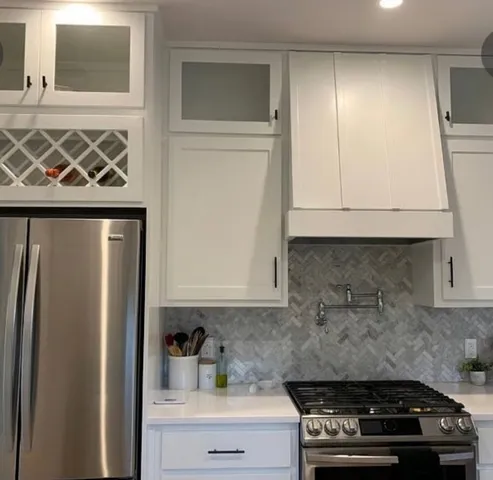 a kitchen with wooden cabinets and a stove top oven
