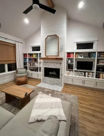 a living room with furniture flat screen tv and a fireplace