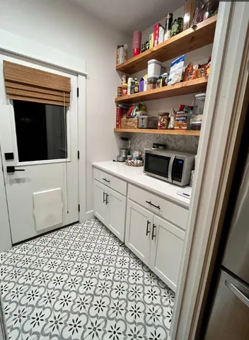 a kitchen with a refrigerator and cabinets