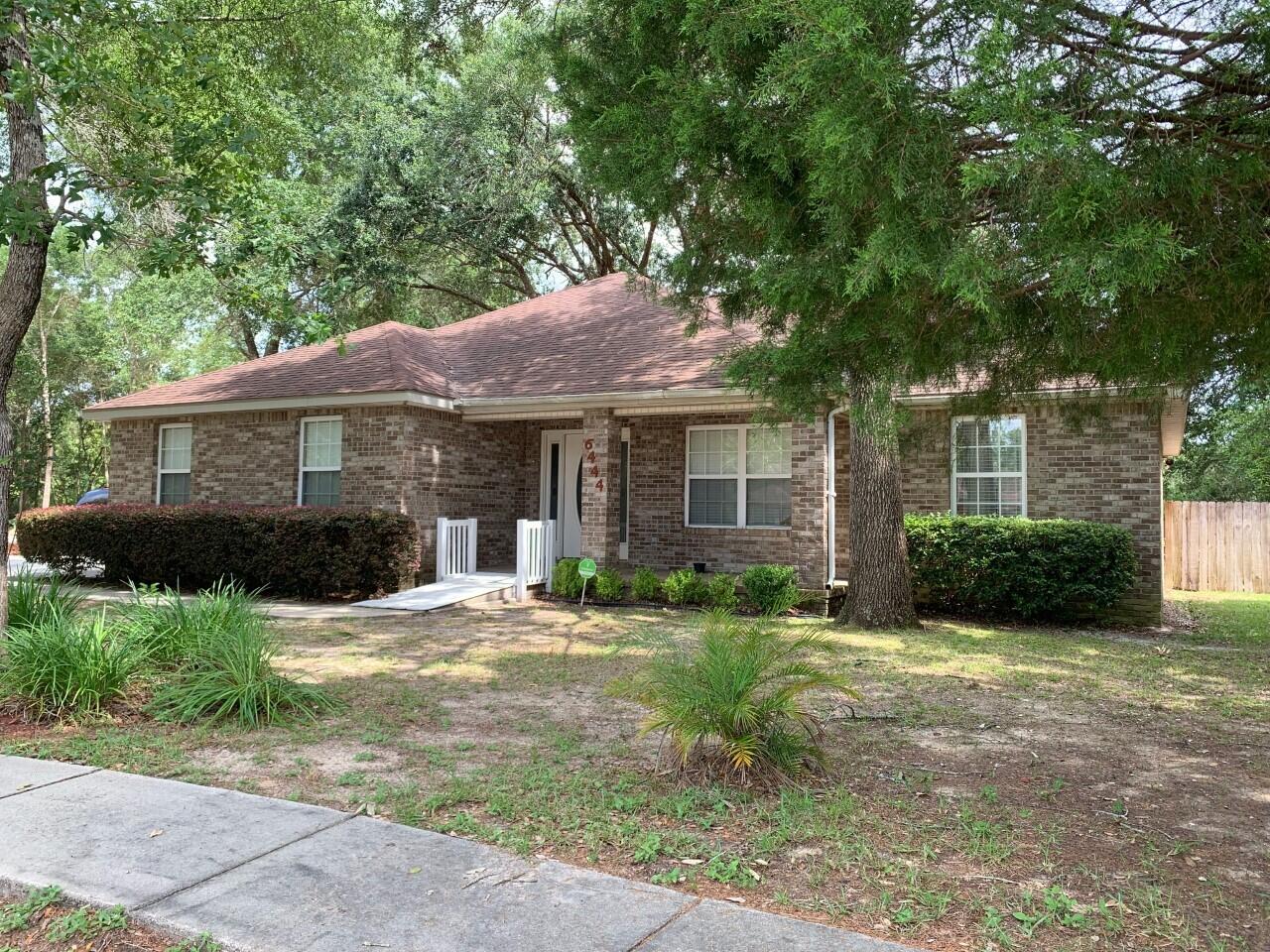 6444 Kylito Circle Crestview, FL 32539 - Photo 1 of 23 a front view of a house with a garden and trees