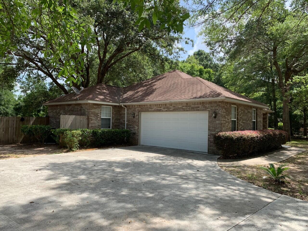 6444 Kylito Circle Crestview, FL 32539 - Photo 2 of 23 a front view of a house with a garden