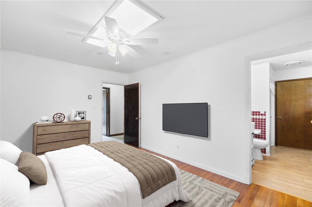 14333 Meranda Road Anna, OH 45302 - Photo 30 of 98 This spacious bedroom offers ample comfort, featuring rich hardwood flooring and convenient access to a private bath.