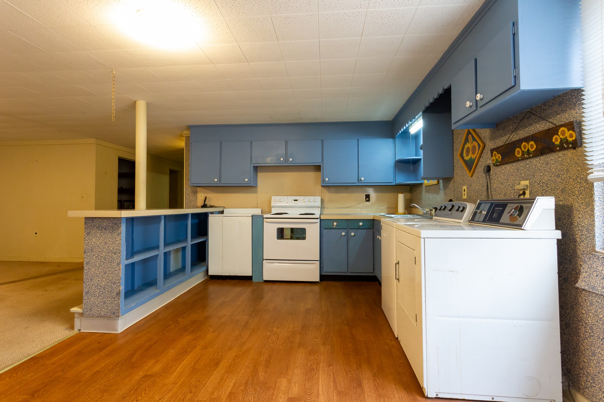 133 Byrd Road Dover, TN 37058 - Photo 16 of 35 a kitchen with a cabinets wooden floor and a view of living room
