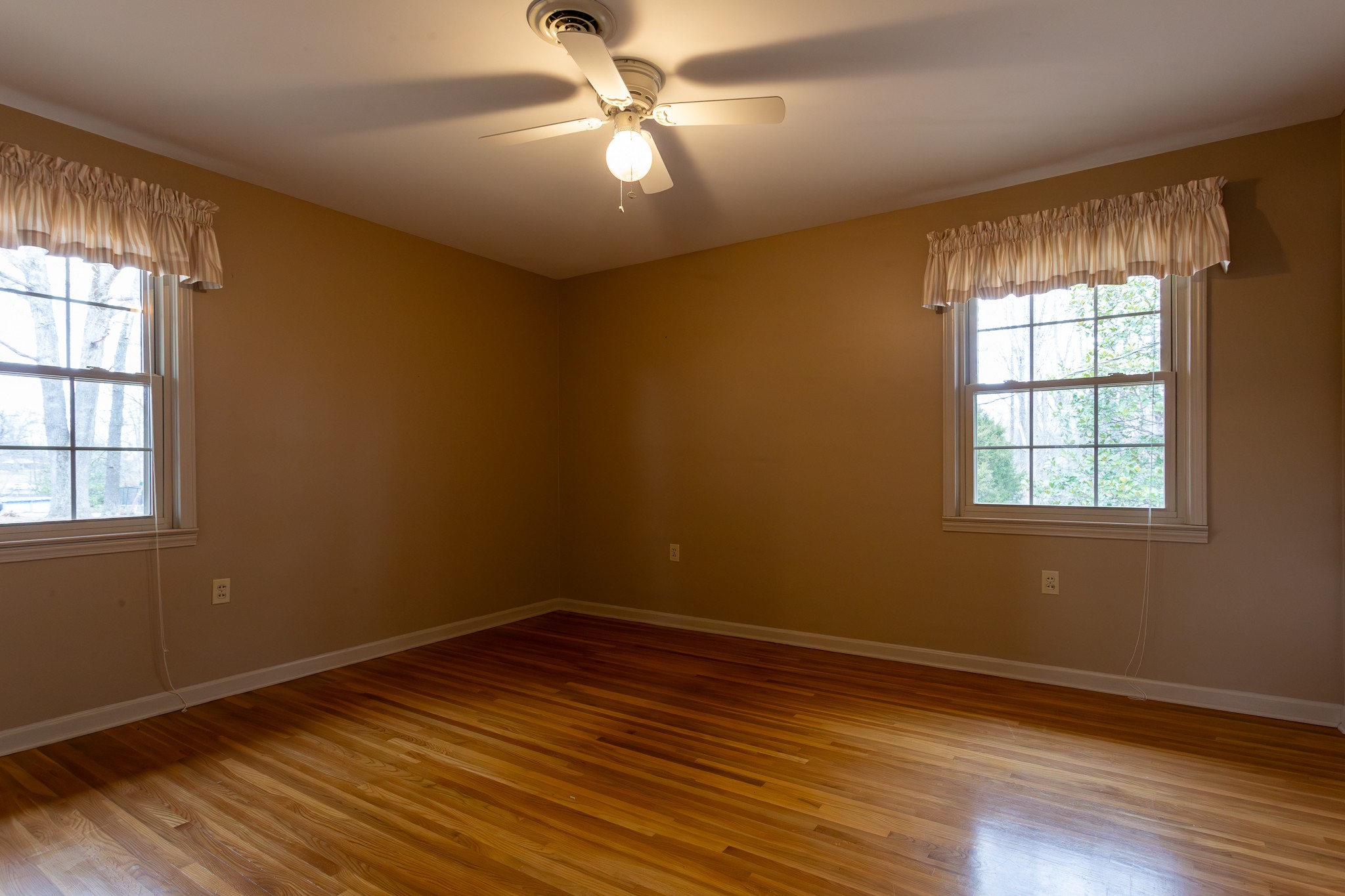 133 Byrd Road Dover, TN 37058 - Photo 9 of 35 an empty room with wooden floor fan and windows