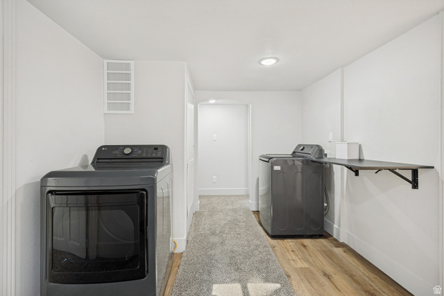 662 29th Street Ogden, UT 84403 - Photo 11 of 23 Dedicated laundry area featuring a built-in folding shelf, recessed lighting, wood-finish flooring, and a neutral color palette