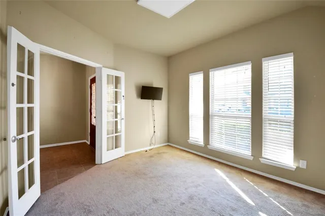 an empty room with windows and closet