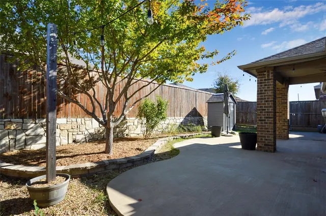 a view of a house with a patio and a yard