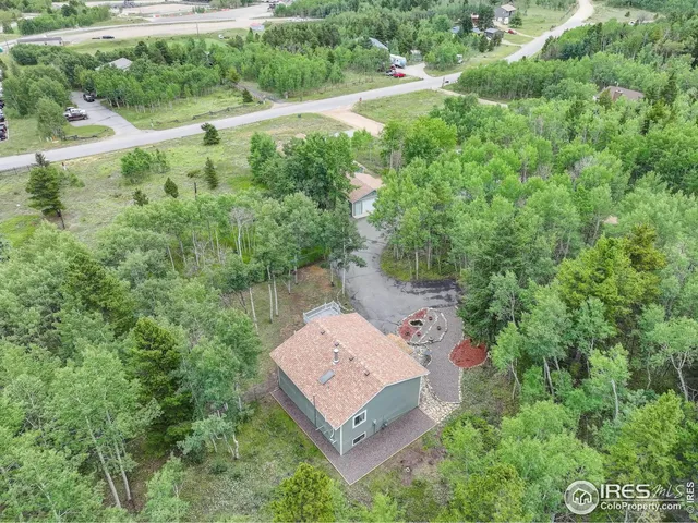 a kitchen with stainless steel appliances granite countertop a refrigerator a sink a stove a washer and dryer with wooden floor