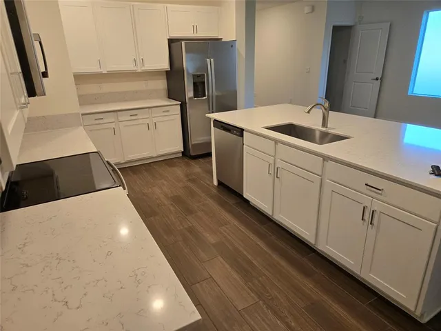 a kitchen with a sink and refrigerator