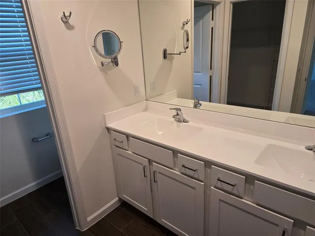 a bathroom with a sink and mirror