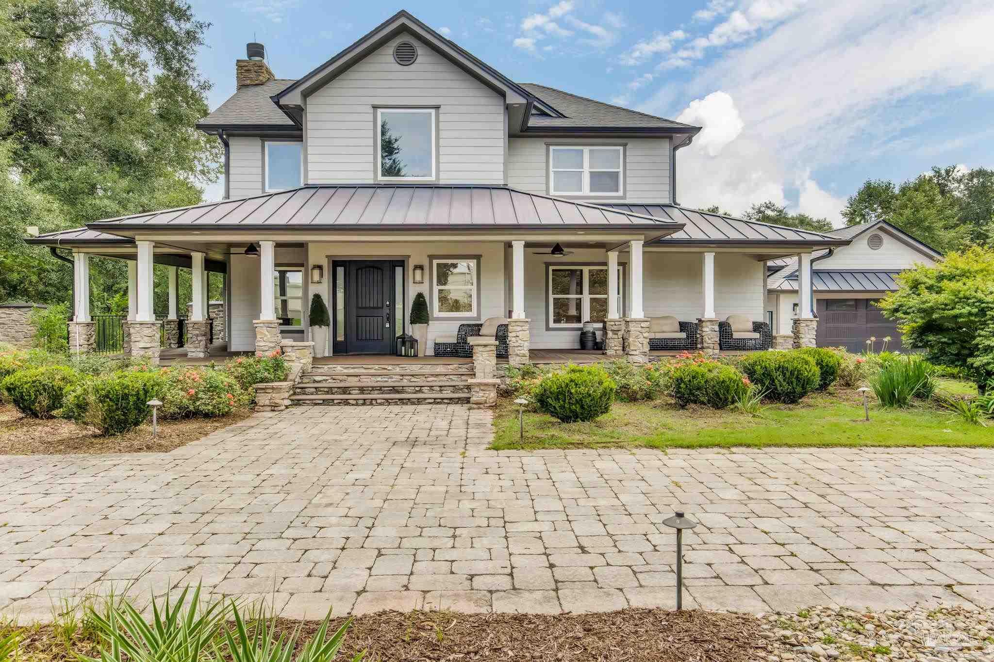 9050 Salter Road Pace, FL 32571 - Photo 1 of 66 a front view of a house with a yard and potted plants