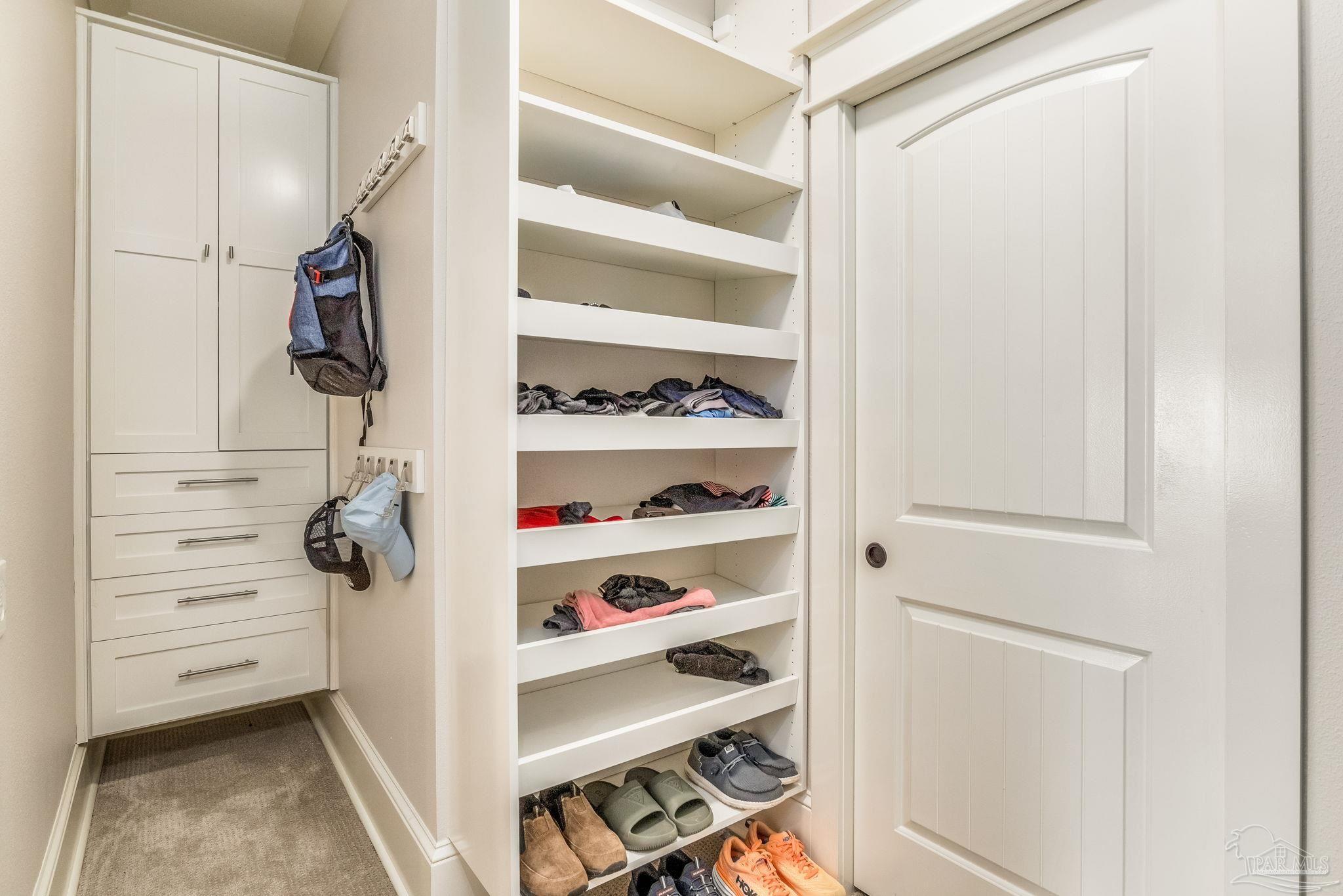 9050 Salter Road Pace, FL 32571 - Photo 18 of 66 a view of walk in closet with empty racks