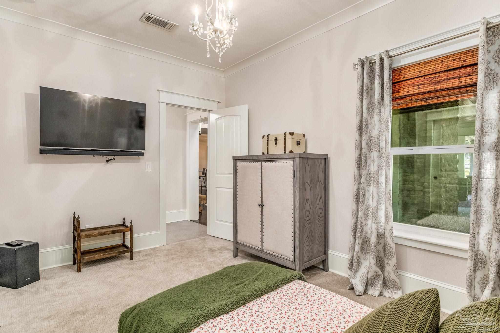 9050 Salter Road Pace, FL 32571 - Photo 19 of 66 a bedroom with furniture and a flat screen tv