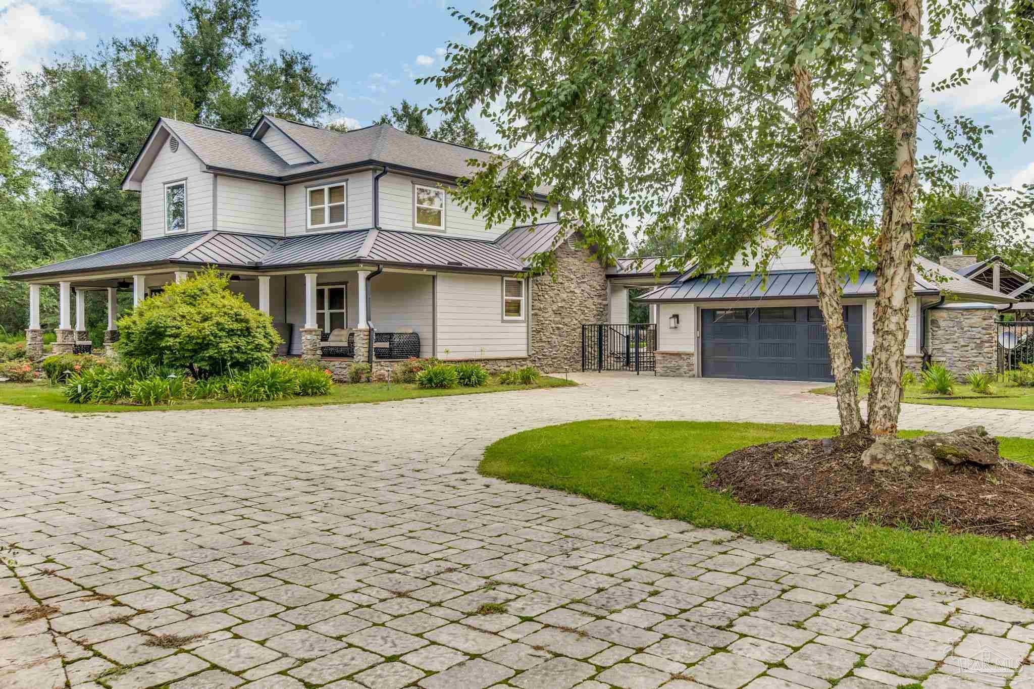 9050 Salter Road Pace, FL 32571 - Photo 2 of 66 a front view of a house with a garden
