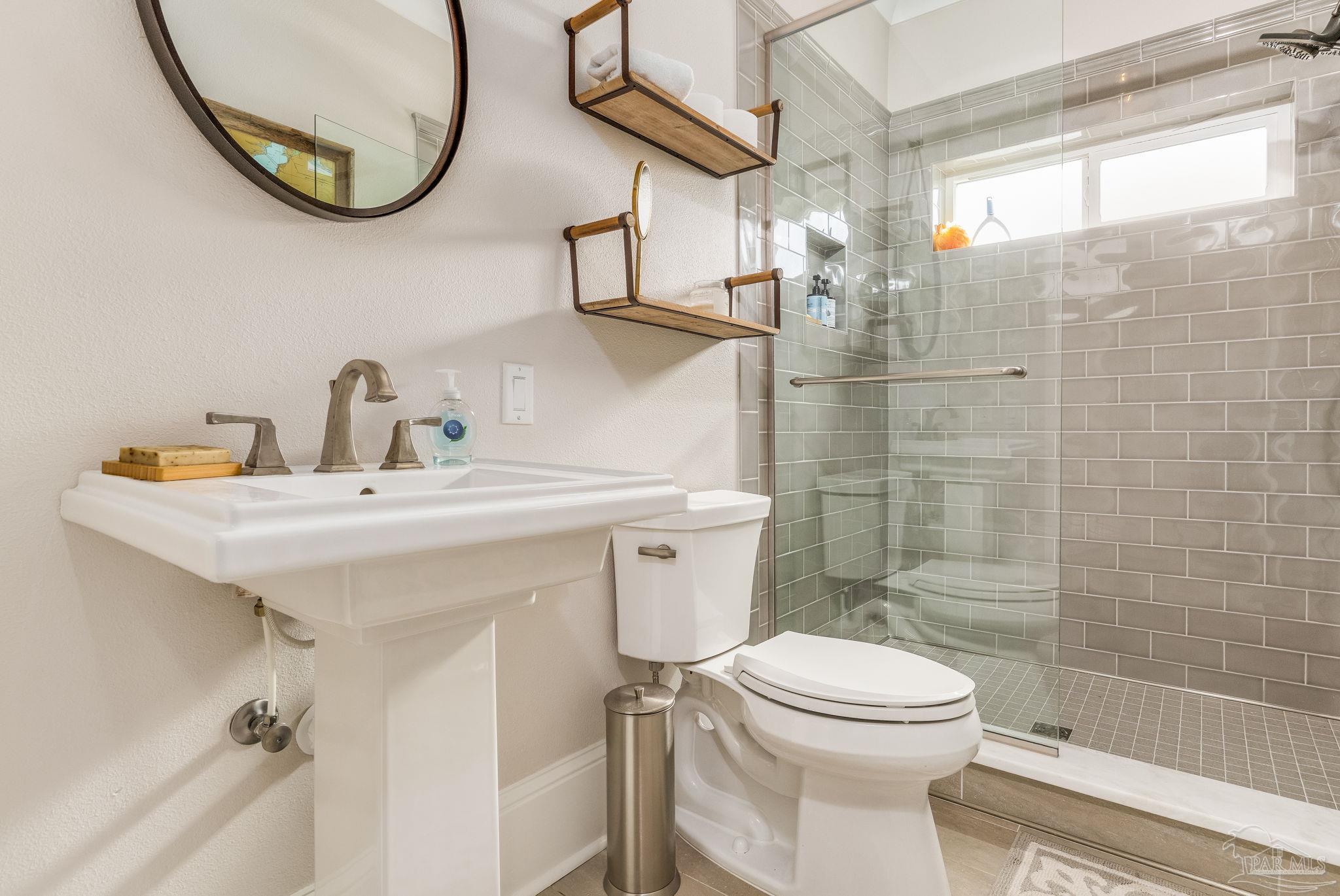 9050 Salter Road Pace, FL 32571 - Photo 21 of 66 a bathroom with a sink a toilet and shower