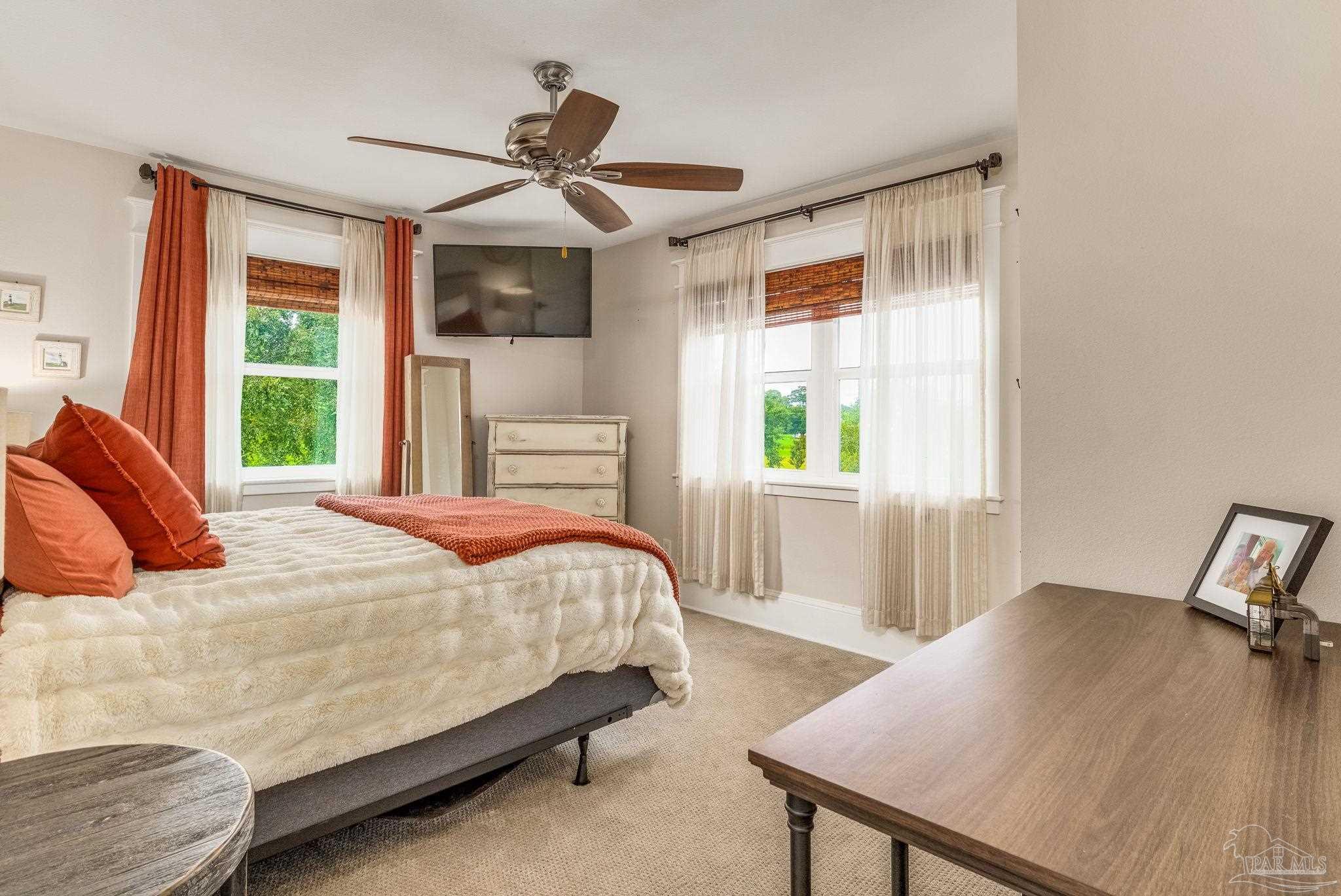 9050 Salter Road Pace, FL 32571 - Photo 24 of 66 a bedroom with a bed a dresser and a window