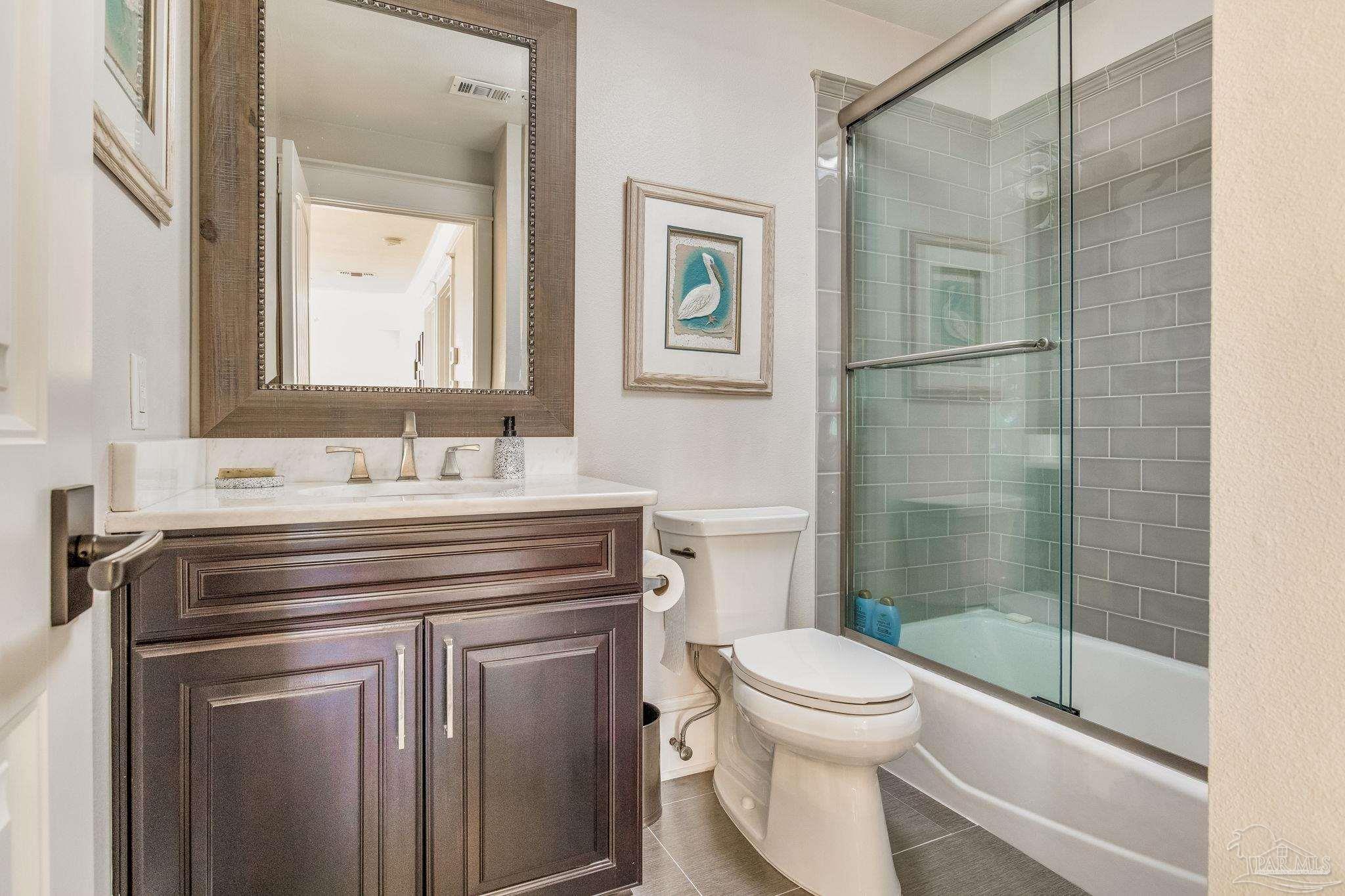 9050 Salter Road Pace, FL 32571 - Photo 26 of 66 a bathroom with a sink toilet and shower