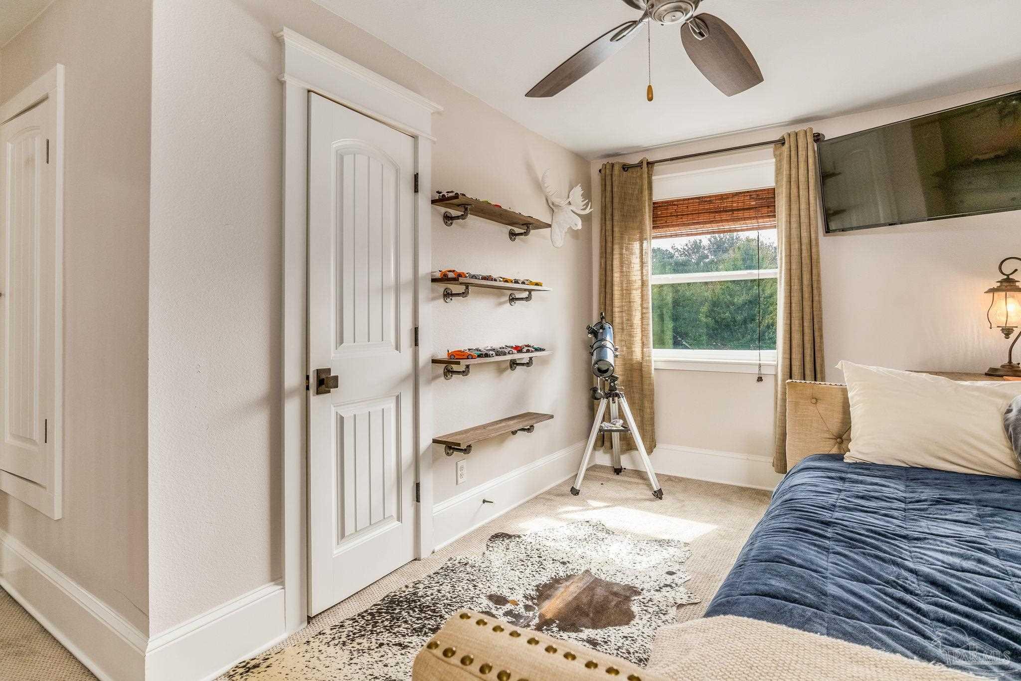 9050 Salter Road Pace, FL 32571 - Photo 28 of 66 a bedroom with a bed and a window