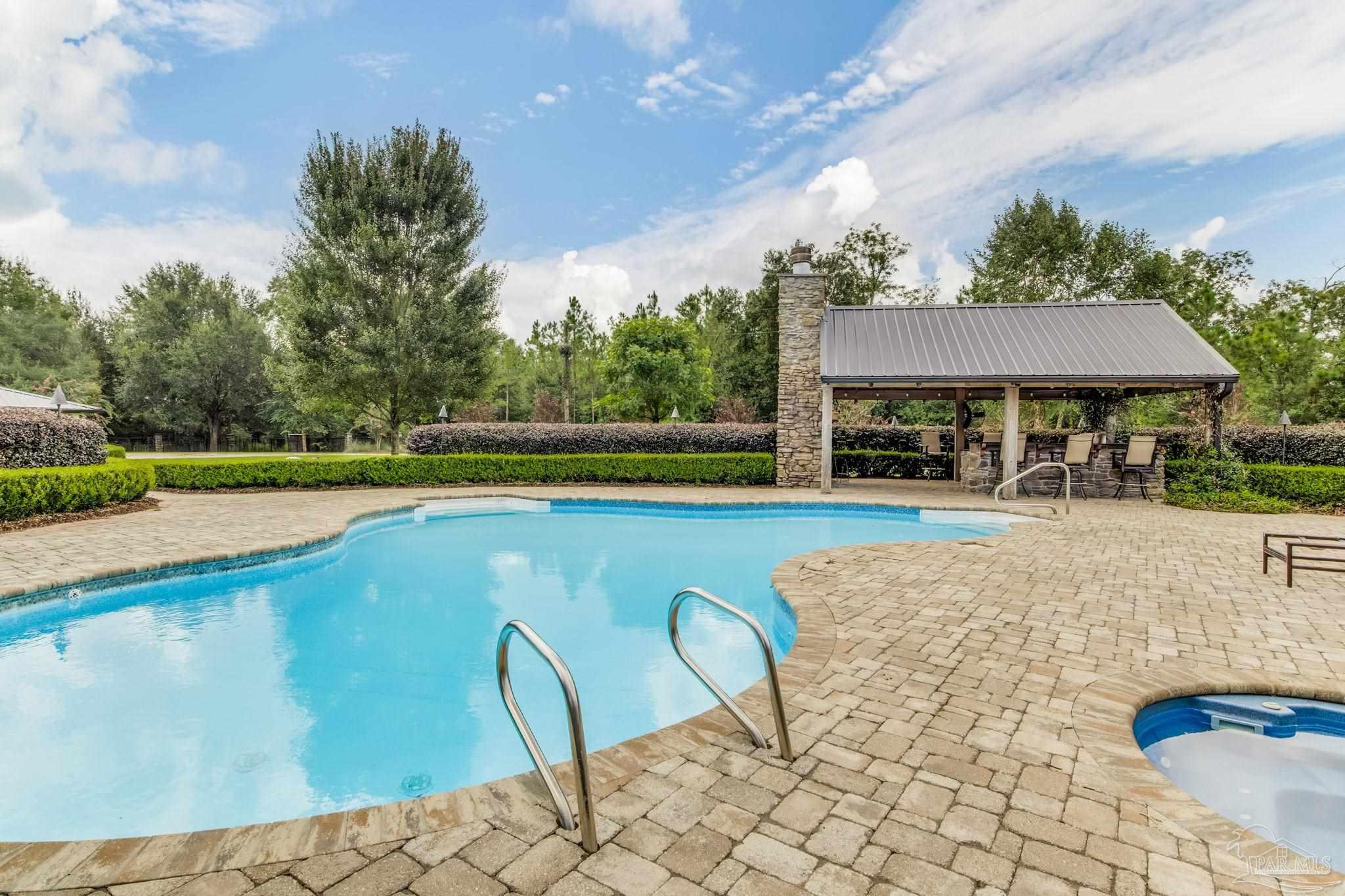 9050 Salter Road Pace, FL 32571 - Photo 33 of 66 a view of swimming pool with seating space