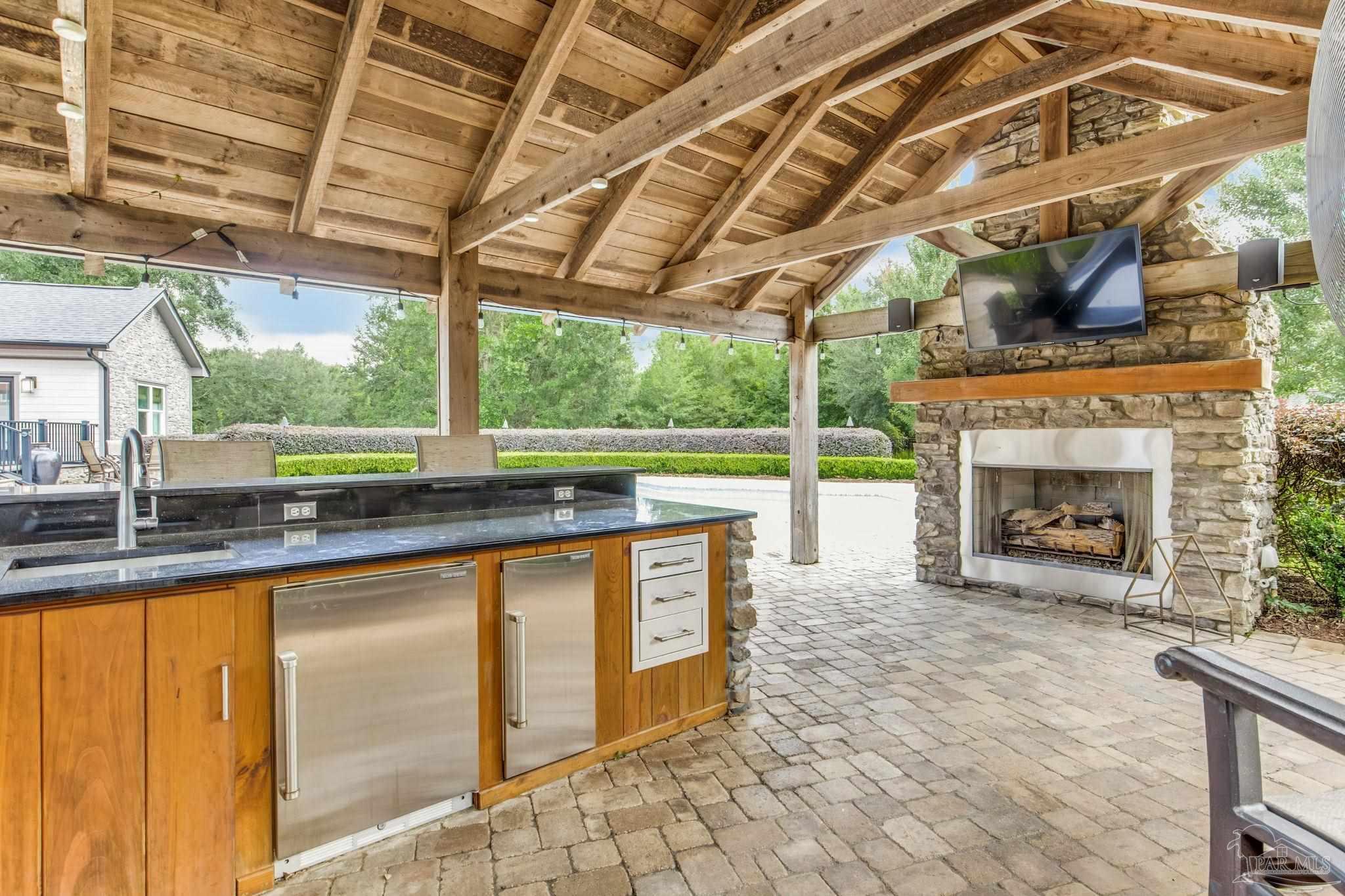 9050 Salter Road Pace, FL 32571 - Photo 35 of 66 a view of open kitchen with granite countertop a sink and a counter top space