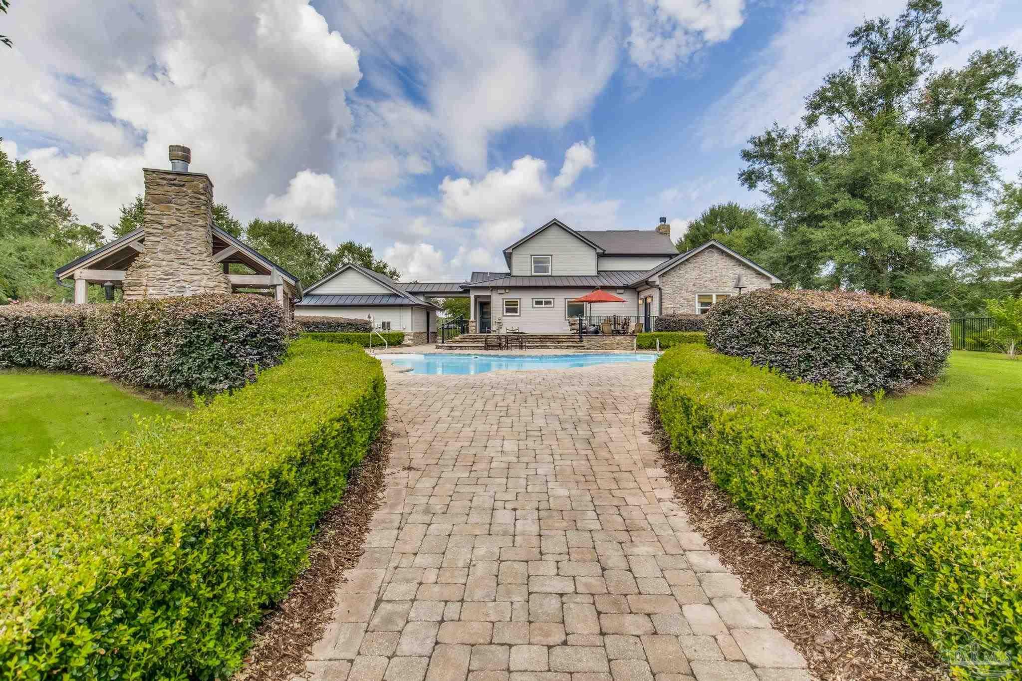 9050 Salter Road Pace, FL 32571 - Photo 38 of 66 a view of a house with a yard