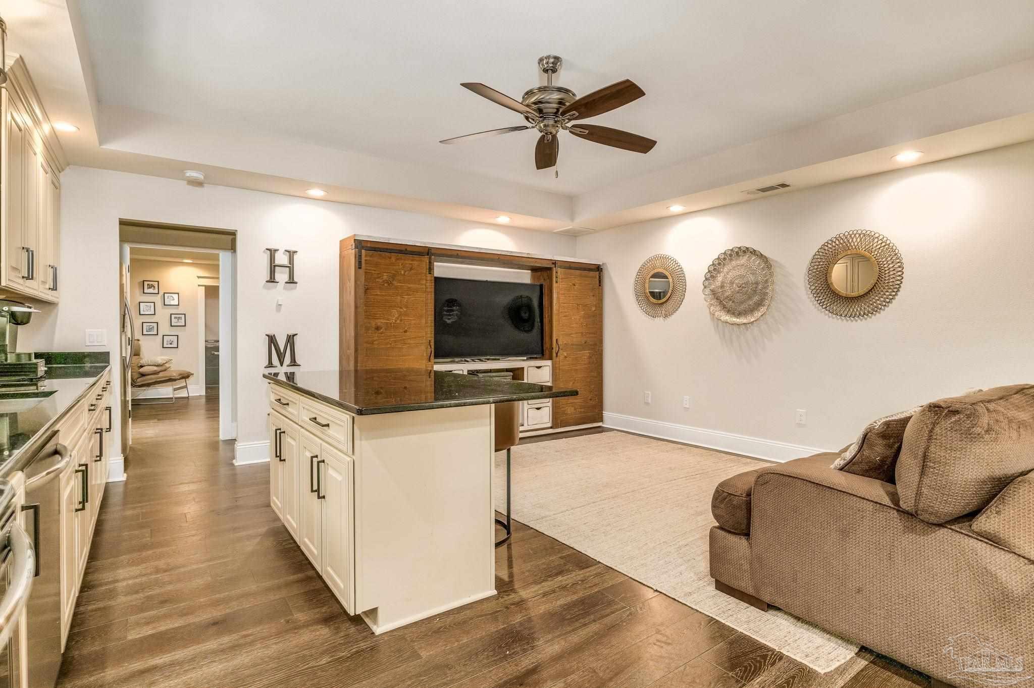 9050 Salter Road Pace, FL 32571 - Photo 42 of 66 a living room with furniture and a flat screen tv