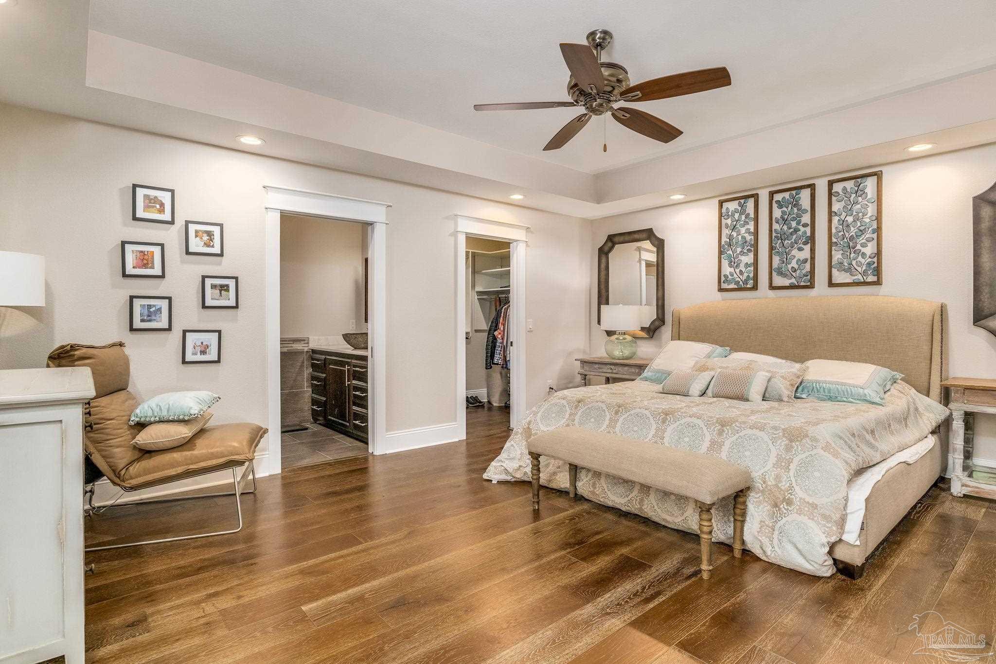 9050 Salter Road Pace, FL 32571 - Photo 46 of 66 a spacious bedroom with a bed and ceiling fan