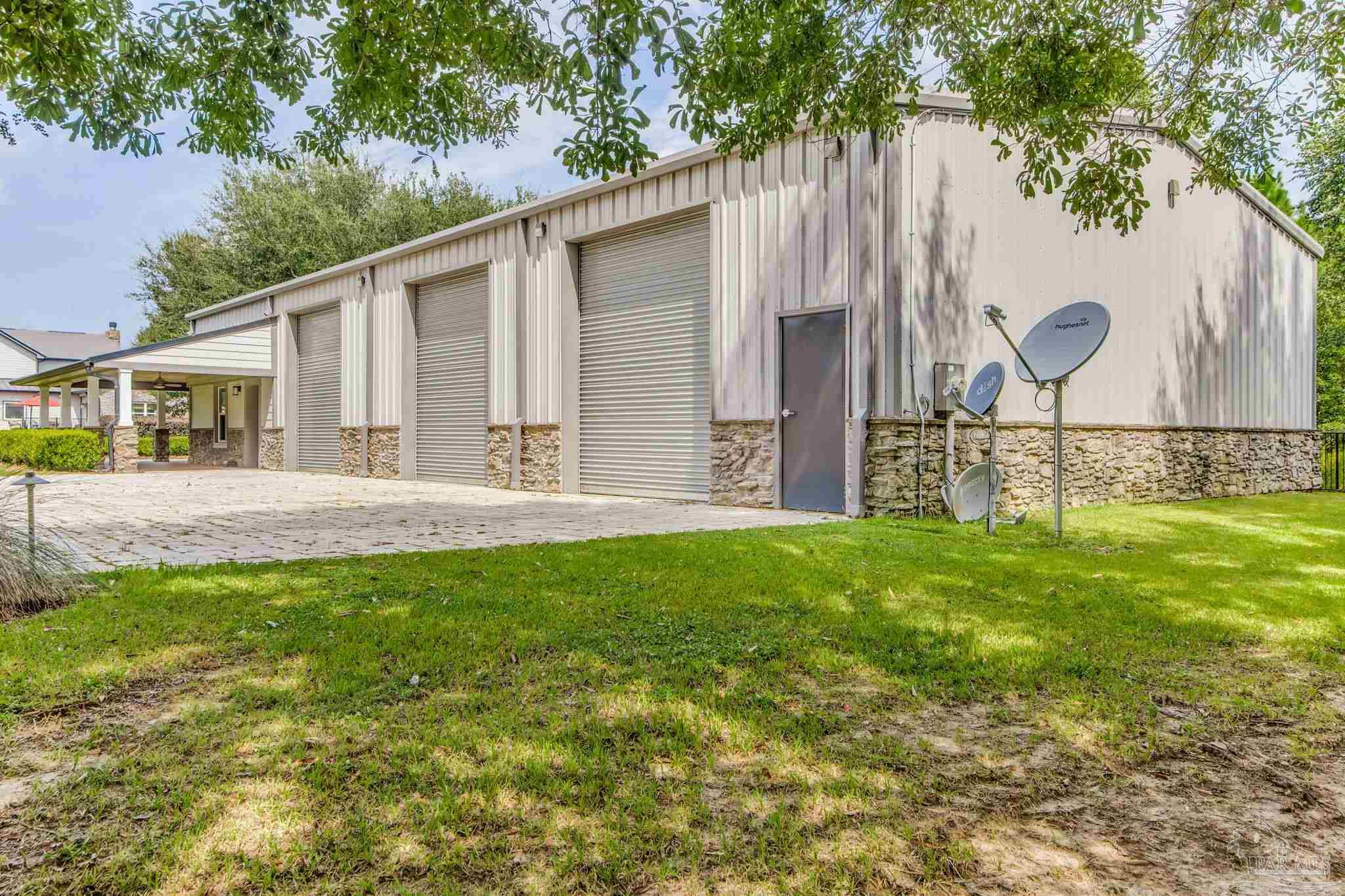 9050 Salter Road Pace, FL 32571 - Photo 5 of 66 a backyard of a house with table and chairs