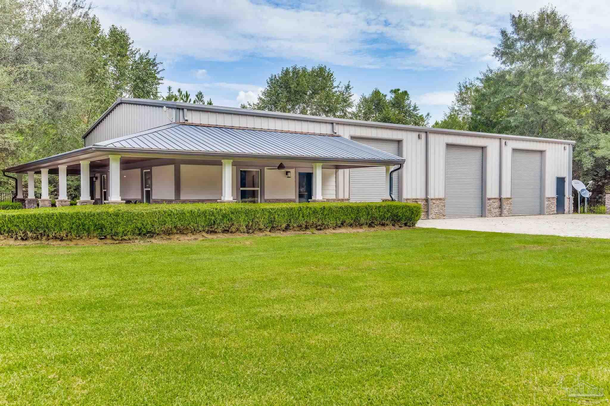 9050 Salter Road Pace, FL 32571 - Photo 51 of 66 a front view of house with yard and green space