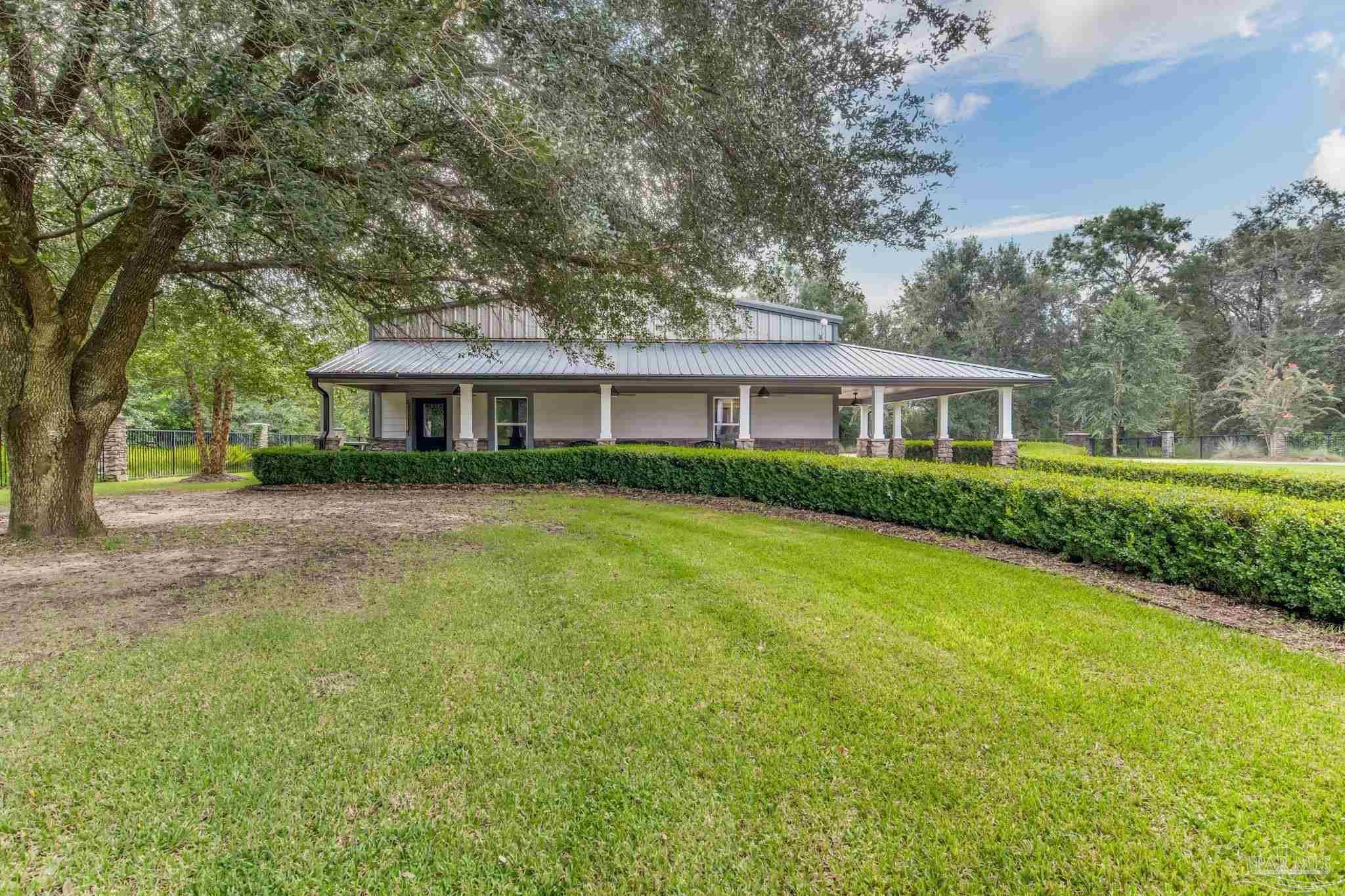 9050 Salter Road Pace, FL 32571 - Photo 60 of 66 a front view of a house with a yard