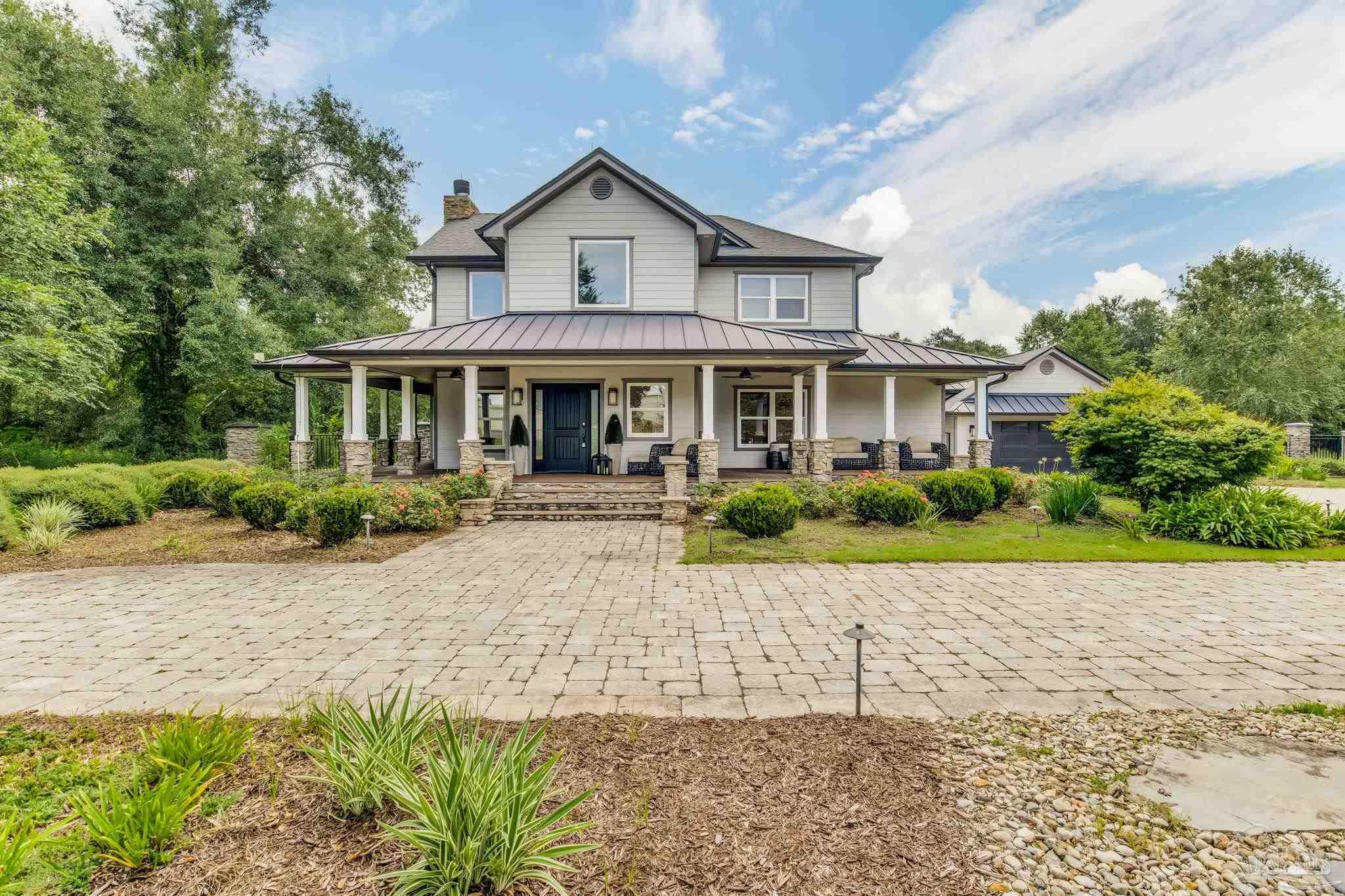 9050 Salter Road Pace, FL 32571 - Photo 62 of 66 a front view of a house with a yard