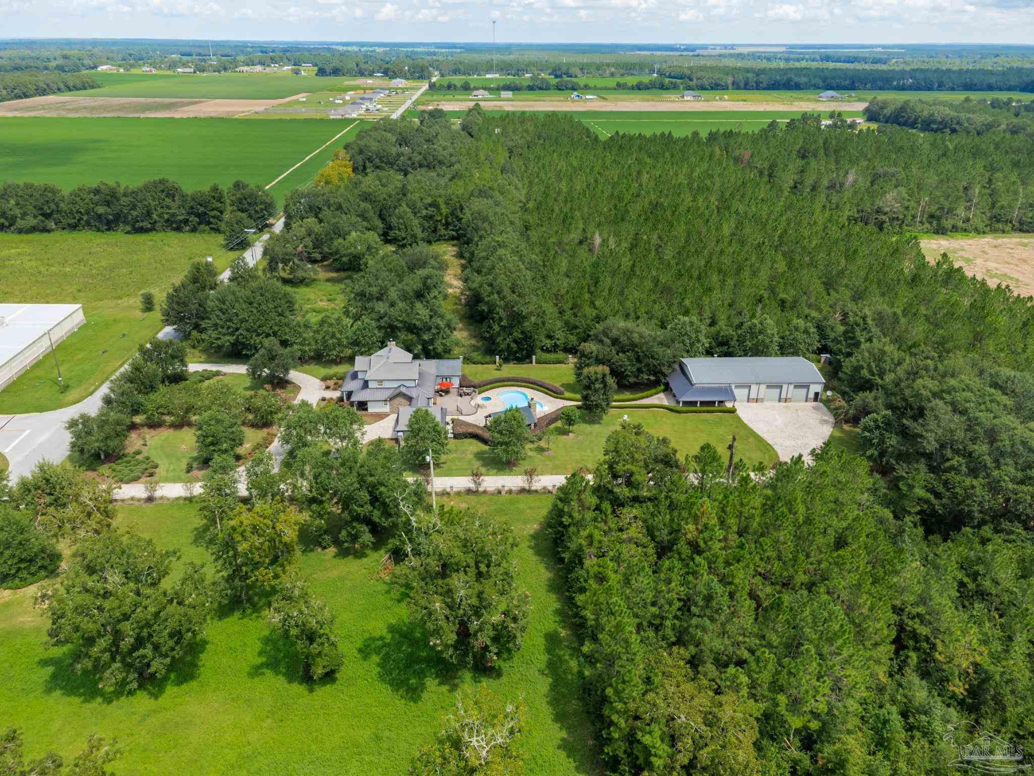 9050 Salter Road Pace, FL 32571 - Photo 63 of 66 a view of a lake with a houses