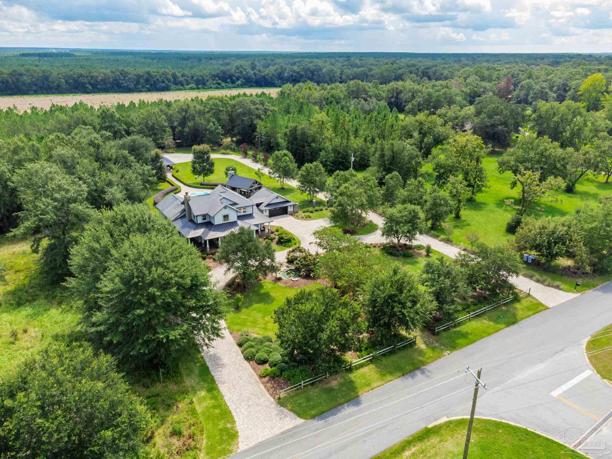 9050 Salter Road Pace, FL 32571 - Photo 64 of 66 a view of a lake with a yard