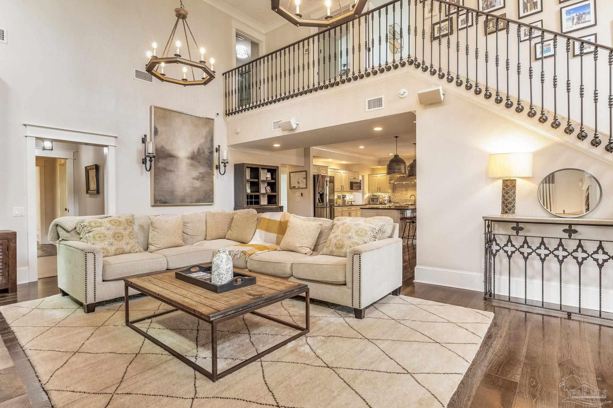 9050 Salter Road Pace, FL 32571 - Photo 8 of 66 a living room with furniture a chandelier and kitchen view