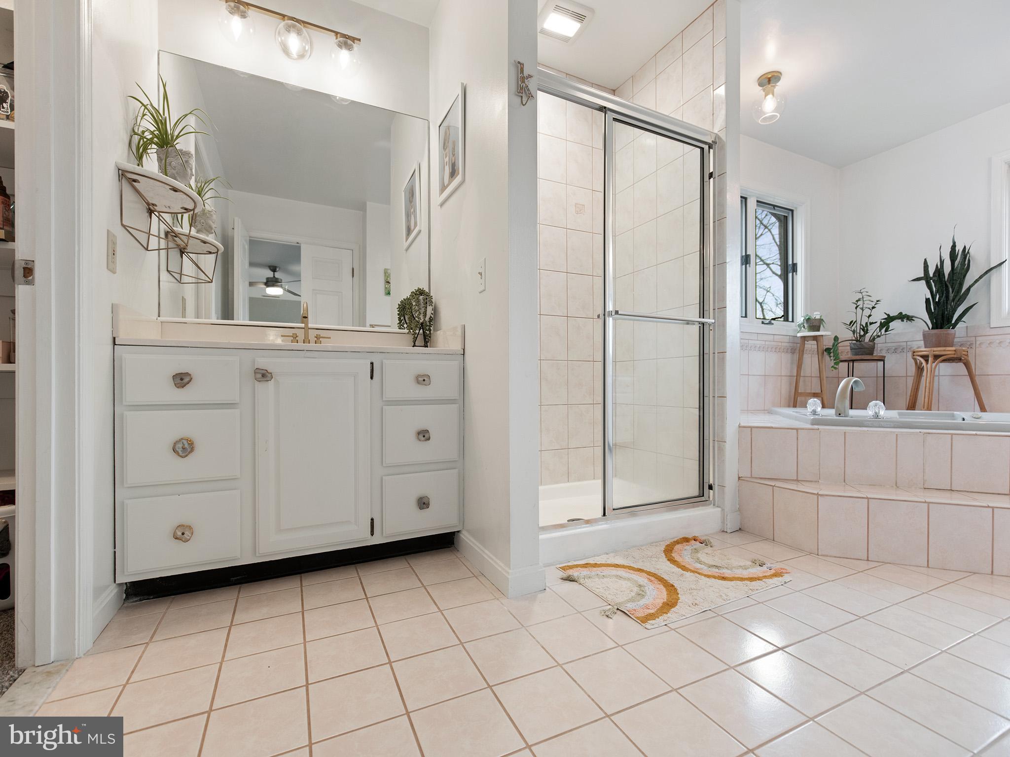 819 Big Road Lusby, MD 20657 - Photo 30 of 55 Primary bath with tile floors, shower surround