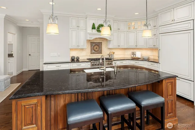 a kitchen with a table chairs sink and cabinets