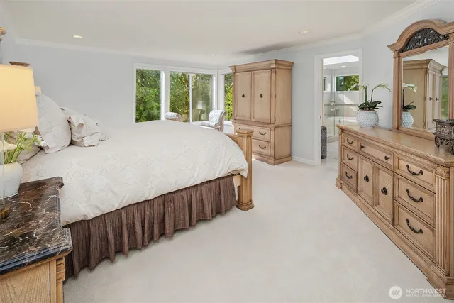 a spacious bedroom with a bed and a dresser